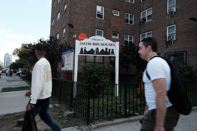 People walk through the Jacob Riis Houses as residents and activists gather for a protest against the living conditions at the public housing unit on September 14. At a City Council hearing investigating the arsenic scare in water at the complex on September 22, members grilled NYCHA officials over a timeline of events.
